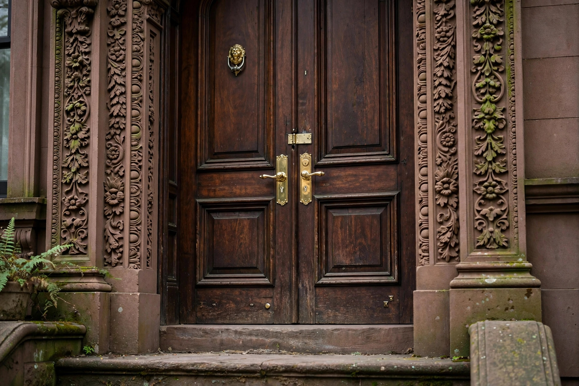 Ornate brownstone entrance with brass door hardware on the Upper West Side